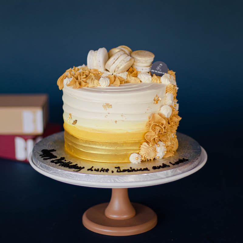 Gold Ombre Cake with Piped Cream and Macarons